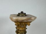 a marble pedestal with a brass base and a marble top