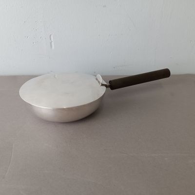 a pan with a handle sitting on a table