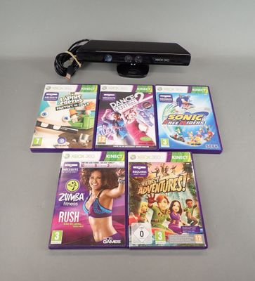 a lot of video games and a remote on the table