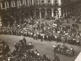 a large crowd of people gathered in a city square