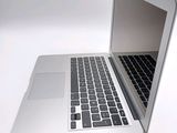 a close up of a laptop computer on a white surface
