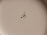 a close up of a white plate with a triangle on it