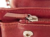 a close up of a red purse with a zipper