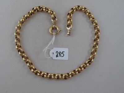 a close up of a gold chain with a price tag in the shape of a heart