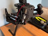 a small black drone sitting on top of a wooden table