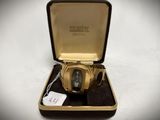 an image of a gold watch in a case with a tag on it
