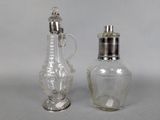 two glass salt and pepper shakers sitting next to each other