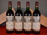 three bottles of red wine sit on a table next to a wooden box
