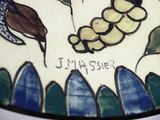 a close up of a decorative plate with a butterfly on it