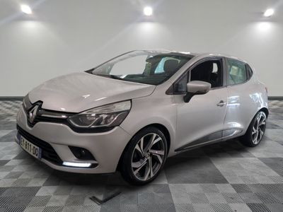 a white car parked in a garage with a checkered floor