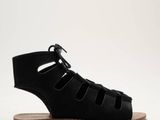 a picture of a pair of black sandals on a white background