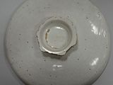 a white plate with a hole in the middle of it