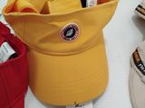 several hats are sitting on a table with a price tag