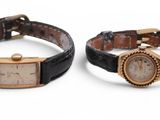 pair of ladies ' s wrist watches with black leather strap and gold tone dial