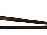 a large knife that is sitting on top of a wooden pole