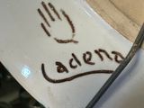 a close up of a plate with a hand drawn on it