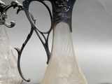 three glass vases sitting next to each other on a table