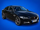 a black jaguar parked in front of a blue background