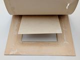 a piece of paper sitting on top of a piece of cardboard