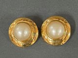 two pairs of gold and pearl earrings on a gray surface
