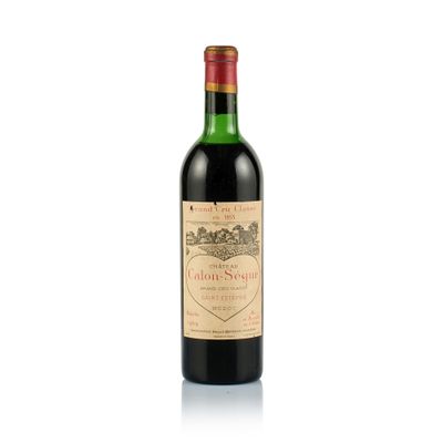 a bottle of wine sitting on top of a white surface