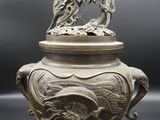 an antique chinese silverware with a dragon on top