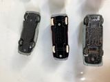 three toy cars sitting next to each other on a table