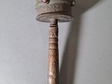 a small metal object with a red dot on it