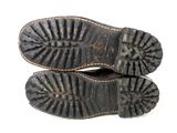 pair of old black leather shoes on a white background