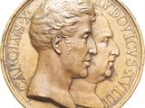 l'image d'une pièce d'or sur laquelle figurent deux visages, celui d'une femme et celui d'un homme
