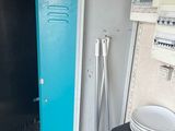 a blue locker and a stack of plates in a kitchen
