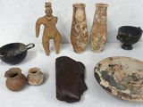 several pieces of pottery sitting on a white surface next to other items