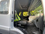 a white van with a black seat and a yellow safety vest