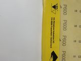 a yellow ticket with a sticker on it on a white surface