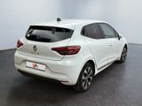 the rear end of a white car parked in a room