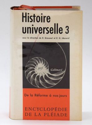 a book with an orange cover sitting on top of a white table