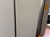 two white refrigerators in a room next to each other