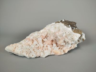 white and brown rock with a small piece of rock on top