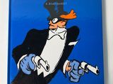 a blue book with a picture of a man in a tuxedo