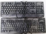two keyboards sitting next to each other on a table
