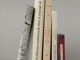 several books are stacked on top of each other on a table