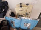 three bags of hair products sitting on a table