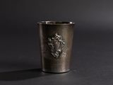 a shot of a silver cup with a crest on it