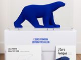 blue sculpture of a polar bear sitting on top of a white box