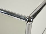 a close up view of a glass shelf with a metal handle