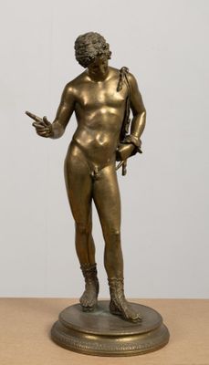 bronze statue of a male nude torsoed man holding a sword