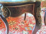 a small table with a glass top on a rug