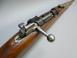 an old rifle with a wooden handle on a white surface