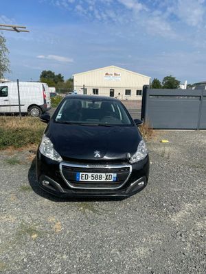 the small black car is parked in the parking lot