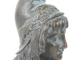 bronze statue of a woman with a feathered hat on her head